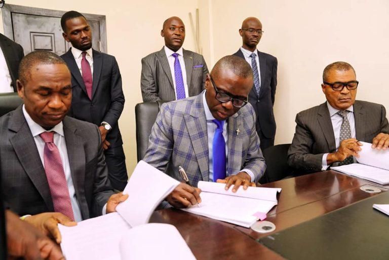 L-R: Mr Obafemi Hamzat, Lagos State Deputy Governor-elect; Mr Babajide Sanwo-Olu,  Governor-elect; Mr Demola Seriki, APC chieftain, on Tuesday signing a response to two gubernatorial electoral petitions filed against APC at a tribunal in  Ikeja [nan]
