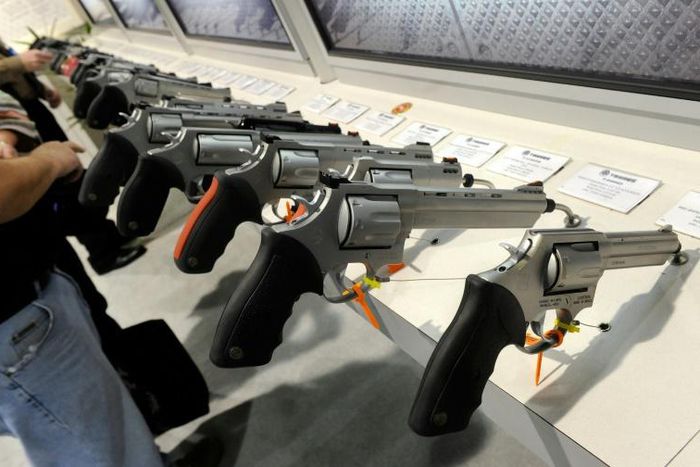 Handguns are displayed at the Taurus International Firearms booth at a gun show in 2011 in Las Vegas