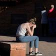 Maren Strother, 16, rests her head on her hands at a vigil in Littleton, Colorado to the April 20, 1999 mass shooting at Columbine High School
