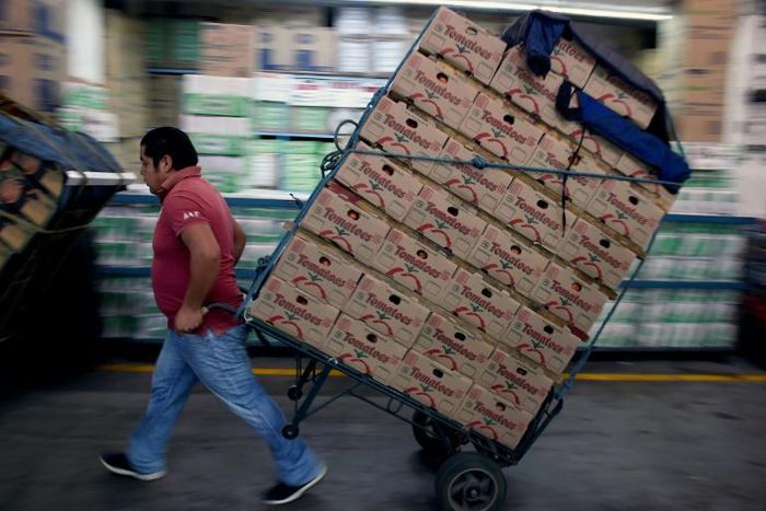 A worker pulls a cart at the "Central de Abasto" wholesale market in Mexico City on January 14, 2019