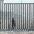 Accused of unjustified shootings: a US Border Patrol officer stands in front of the border fence that divides the US and Mexico at Friendship Park in San Diego, California