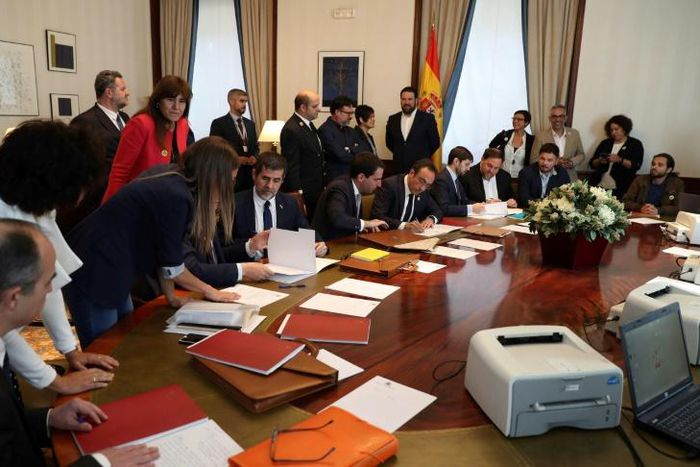 Jailed Catalan separatists and elected members of parliament Jordi Turull, Jordi Sanchez, Josep Rull and Oriol Junqueras registered as MPs in parliament after being temporarily released to obtain their formal certificates of office