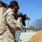 A fighter loyal to the internationally recognised government in Tripoli holds a position south of the capital as forces under commander Khalifa Haftar set their sights on taking the capital