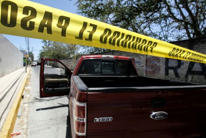Police guard the site where forensic investigators have exhumed bodies from a mass grave in a farm in Zapopan, in Mexico's Jalisco state