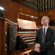 Notre Dame organist Johann Vexo sits at the organ of the Basilica of the National Shrine of the Immaculate Conception in Washington, DC, where he said the organ he played at the burned-out Paris cathedral can probably be cleaned with being taken apart