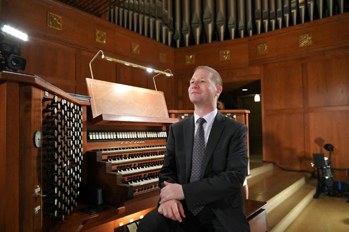 Notre Dame organist Johann Vexo sits at the organ of the Basilica of the National Shrine of the Immaculate Conception in Washington, DC, where he said the organ he played at the burned-out Paris cathedral can probably be cleaned with being taken apart