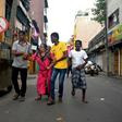 Colombo residents flee their home in fear of a car bomb near St. Anthony's Shrine in the wake of coordinated attacks