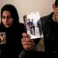 The daughter and son (pictured April 2019) of Zaki Mubarak, whose body was transferred to Cairo after Ankara said he had committed suicide in prison, hold his picture during an interview in their family home