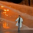 A Moroccan teacher walks through a water cannon during a demonstration calling for permanent contracts