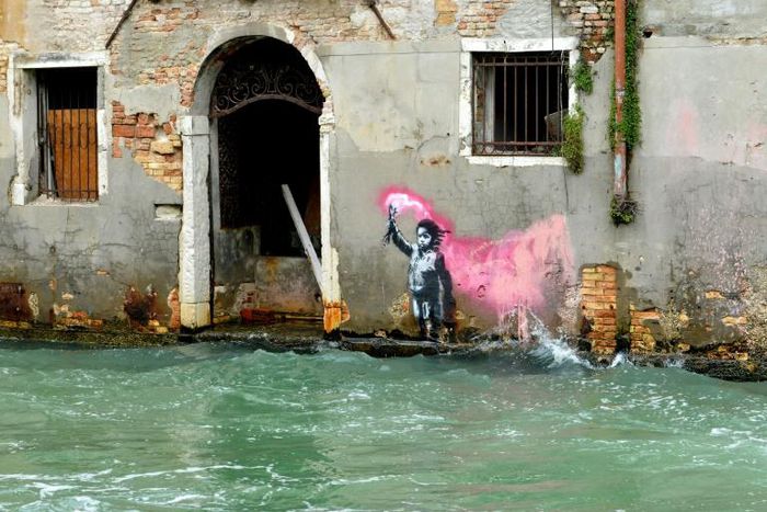 This image, presumed to be by Banksy, appeared on the outer wall of a house overlooking the canal Rio de Ca Foscari, in Venice