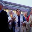 People hold a candlelight vigil for victims of the attack on a synagogue in California