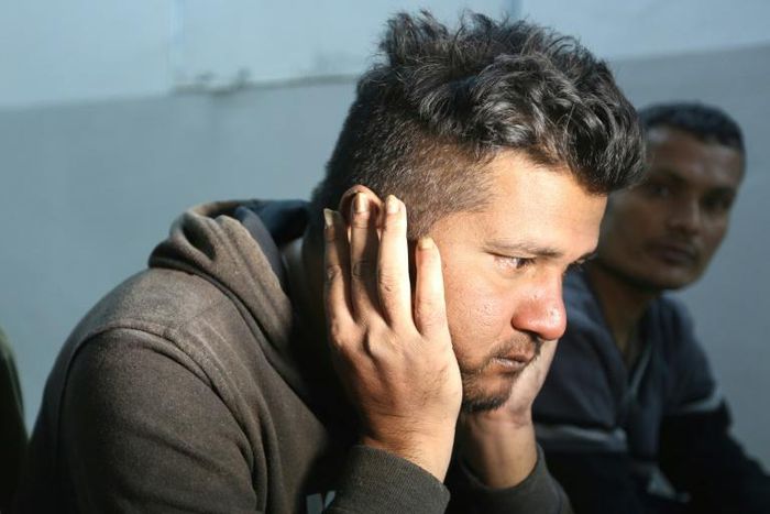 Ahmed Bilal, a Bangladeshi who survived a migrant shipwreck that killed dozens, rests at a shelter in the Tunisian coastal city of Zarzis on Saturday