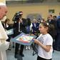 Pope Francis meets a young girl in a refuge camp in Bulgaria where he spoke of their sufferings and the need for others to help them