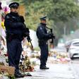 Armed police officers stand guard outside one of the mosques where some 50 people were killed by a self-avowed white supremacist gunman on March 15 in Christchurch