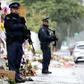 Armed police officers stand guard outside one of the mosques where some 50 people were killed by a self-avowed white supremacist gunman on March 15 in Christchurch