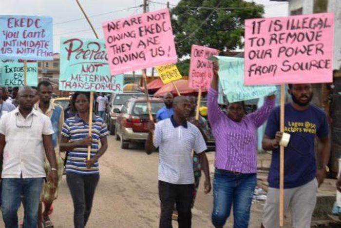 An illustrative photo of protesters carrying placards with messages to electricity distribution companies  [nigeriaelectricityhub]