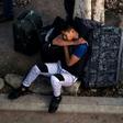 An asylum seeker rests outside El Chaparral port of entry while he waits for his turn to present himself to US border authorities to request asylum, in Tijuana, Mexico, on April 9, 2019