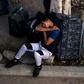 An asylum seeker rests outside El Chaparral port of entry while he waits for his turn to present himself to US border authorities to request asylum, in Tijuana, Mexico, on April 9, 2019