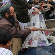 In this picture taken on March 23, 2019 Afghan men uncover the dead bodies of young children laying in the back of a truck, after being killed in an air strike in Kunduz Province.At least 13 civilians were killed, mostly children, in an air strike by "...
