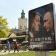 A campaign billboard reads "April 21st. Decisive choice!", bearing the portraits of Ukrainian President Petro Poroshenko and Russian President Vladimir Putin in the center of the western Ukrainian city of Lviv