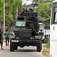 Soldiers patrol in Kalmunai where three suicide bombers blew themselves up during a raid by troops and police on Friday