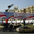 Egyptians pass under banners reading in Arabic "Do what is right", and "Participation is your responsibility", urging voters to participate in a referendum on constitutional amendments