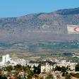 The Kyrenia mountain range, in the north of Cyprus, daubed with the Turkish flag and a quote by Turkey's late founder Ataturk, overlooks the island's divided capital of Nicosia, and can be plainly seen on the Greek Cypriot side
