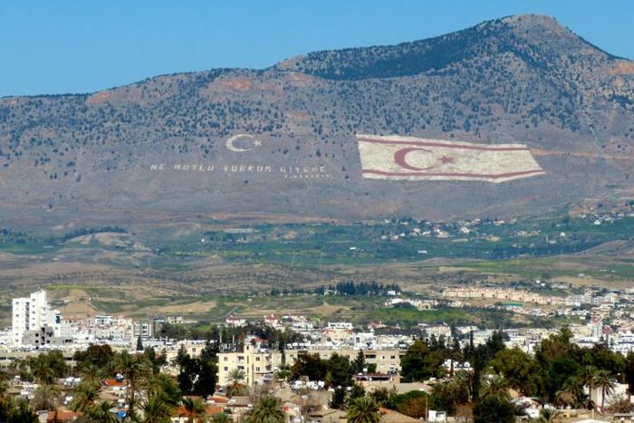 The Kyrenia mountain range, in the north of Cyprus, daubed with the Turkish flag and a quote by Turkey's late founder Ataturk, overlooks the island's divided capital of Nicosia, and can be plainly seen on the Greek Cypriot side