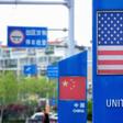 Signs with the US and Chinese flags are displayed in Qingdao free trade port area of Qingdao, in China's eastern Shandong province, ahead of UE President Donald Trump's plan to raise tariffs on $200 billion in Chinese goods