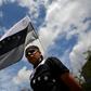 A supporter of Venezuelan opposition leader Juan Guaido holds a black and white version of Venezuela's national flag during a rally in Caracas on May 11, 2019