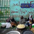 Sudanese women prepare food to be served during the Iftar (breaking of the fast) at sunset during the Muslim holy month of Ramadan, as they protest outside the army headquarters in the capital Khartoum