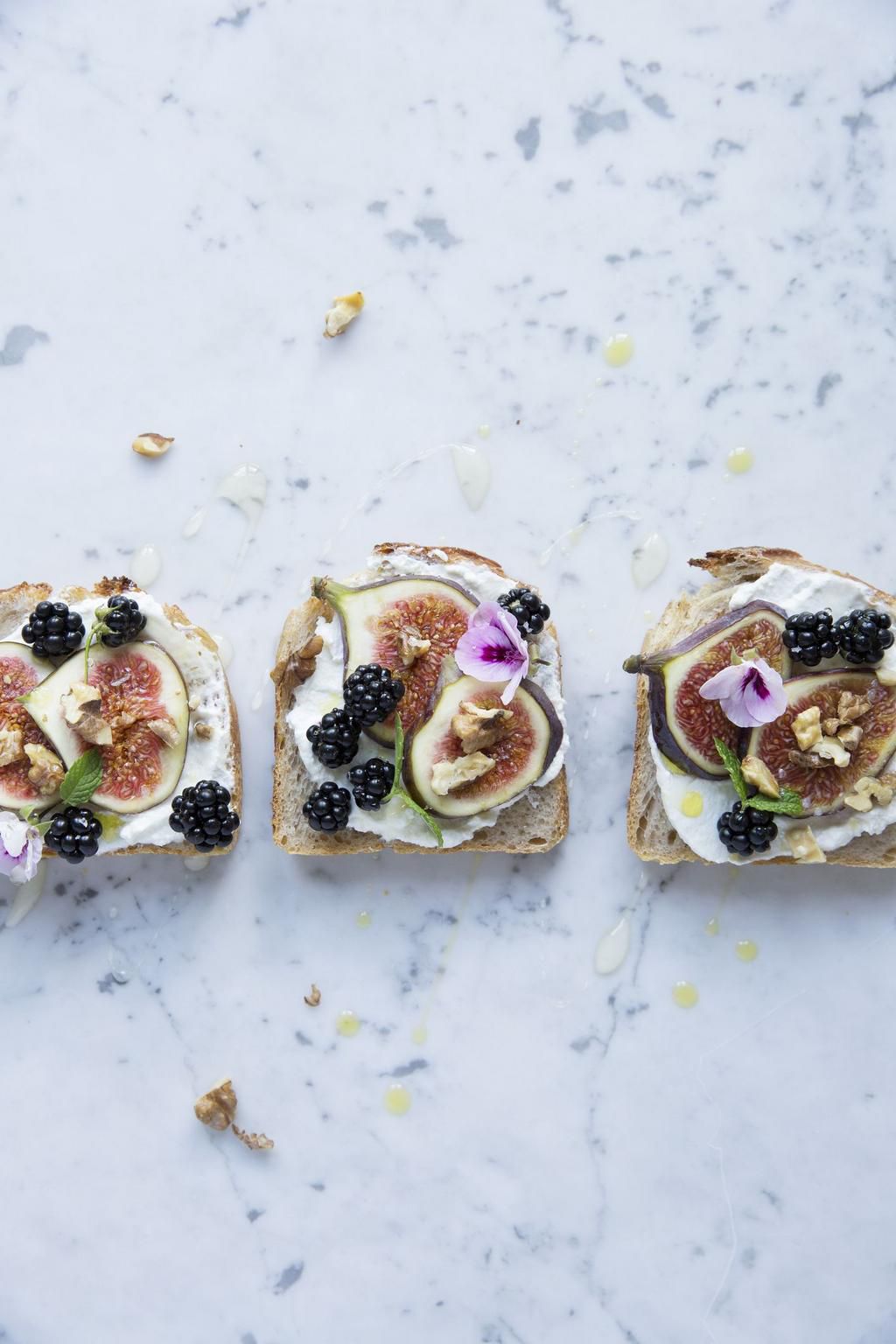 Directly above shot of open faced sandwiches with various fruits