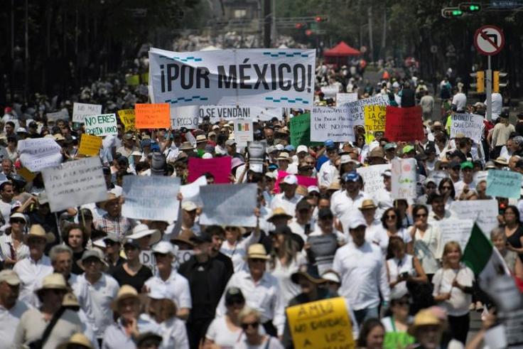 People take part in the so-called "March of Silence" against Mexican President Andres Manuel Lopez Obrador's policies in Mexico City, on May 5, 2019; the economy contracted in the first quarter