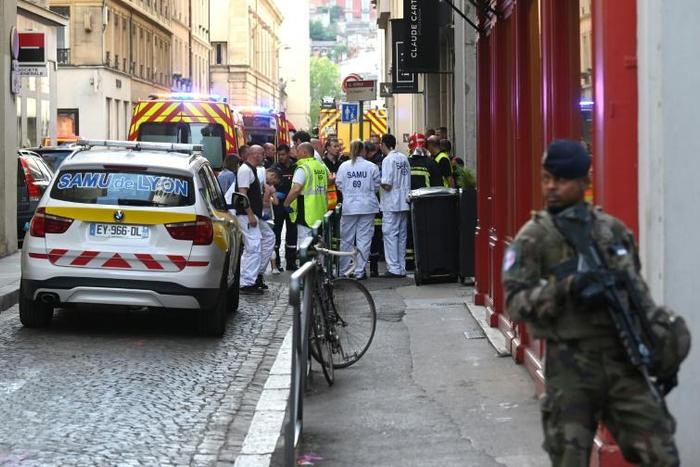 French security and emergency workers block the area following a package bomb blast along a pedestrian street in the heart of Lyon on May 24, 2019