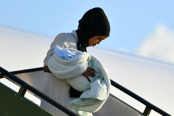 A Libyan mother and child disembark at the Pratica di Mare military airport, on the outskirts of Rome