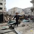Residents walk among debirs caused by the reported explosion of a booby-trapped motorcycle in the city of al-Dana in Syria's rebel-held Idlib region, on the border with Turkey, on April 27, 2019.