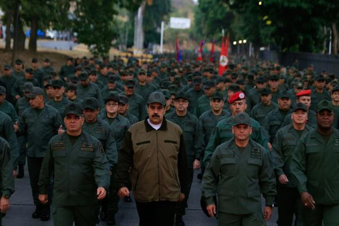 Russia has backed Venezuela President Nicolas Maduro (centre) against the US as analysts say Moscow aims to turn the crisis to its advantage in its global tug-of-war with Washington