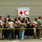 People queue to receive water drums and water purification tablets from the Red Cross in Caracas, Venezuela, on April 16, 2019, after the first shipment of Red Cross humanitarian aid arrived by plane from Panama