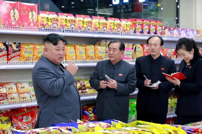 This undated picture released by North Korea's official Korean Central News Agency (KCNA) shows North Korean leader Kim Jong Un (L) visiting a department store