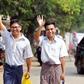 Journalists Wa Lone and Kyaw Soe Oo gesture as they walk out of Insein prison gate after being freed in a presidential amnesty in Yangon on May 7, 2019