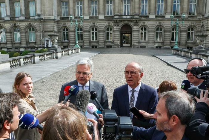 Belgium's Deputy Prime Minister, Minister of Foreign Affairs and Minister of Defence Didier Reynders (L) and former deputy prime minister Johan Vande Lanotte talk to the press after a meeting with the King in Brussels, on May 30, 2019
