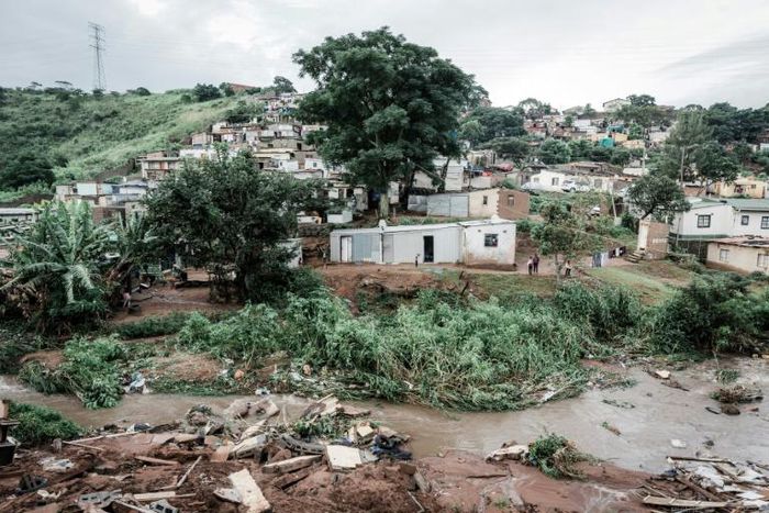 People abandon their homes at an informal settlement of BottleBrush, south of Durban, after torrential rains and flash floods destroyed their homes