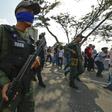Soldiers identify themselves as supporters of Venezuelan opposition leader Juan Guaido with blue sashes