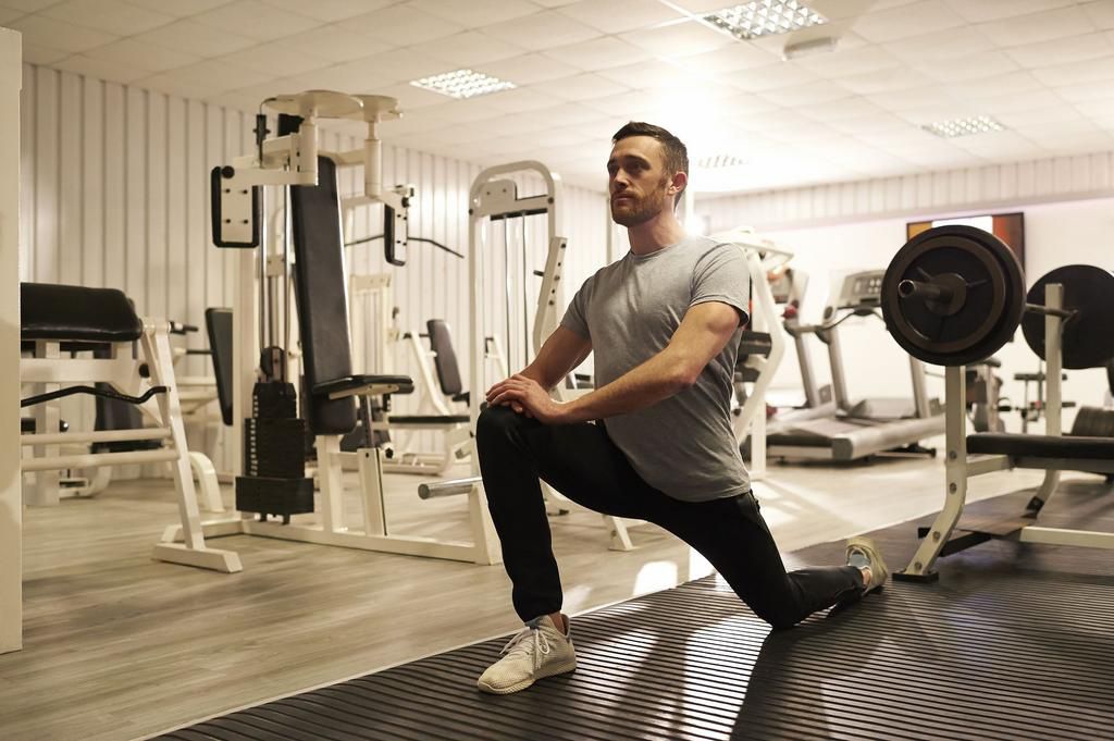 Fit man stretching at gym.