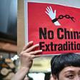 An activist holds a placard during a protest in Hong Kong on April 28, 2019 against a controversial move by the government to allow extraditions to the Chinese mainland
