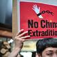 An activist holds a placard during a protest in Hong Kong on April 28, 2019 against a controversial move by the government to allow extraditions to the Chinese mainland