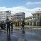 Afghan security personnel and firefighters clean the site of a suicide attack near the Marshal Fahim Military Academy base in Kabul