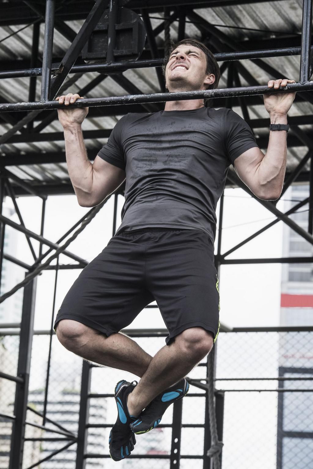 Man doing chin-ups in rooftop gym, Asok, Bangkok, Thailand