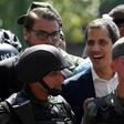 A Brazilian official confirmed there had been "various applications" from Venezuelan soldiers for asylum in the embassy in Caracas after self-declared president Juan Guaido (C) claimed soldiers had joined him