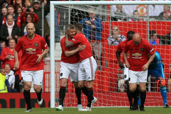 Manchester United '99 Legends celebrate a goal against Bayern Munich in a charity match